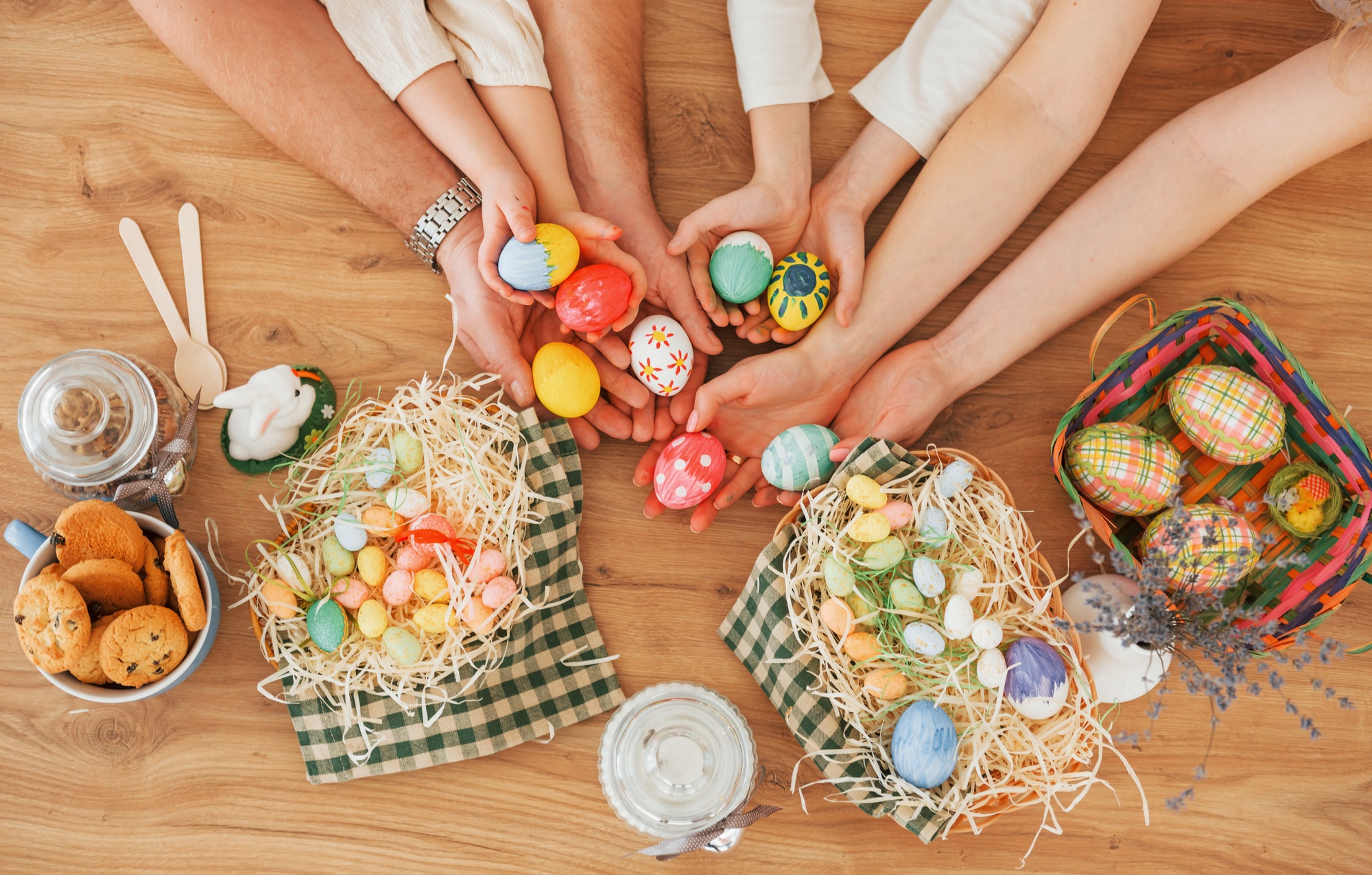 Top view of hands on the table. Happy family celebrating Easter holidays together